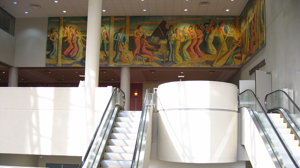 All of the canvas sections that form the continuous scene of dancers and musicians depicted in the 70 foot mural have been installed by McKay Lodge, Inc., for public viewing above the entrance to the ballroom of Battelle Hall of the Greater Columbus Convention Center.