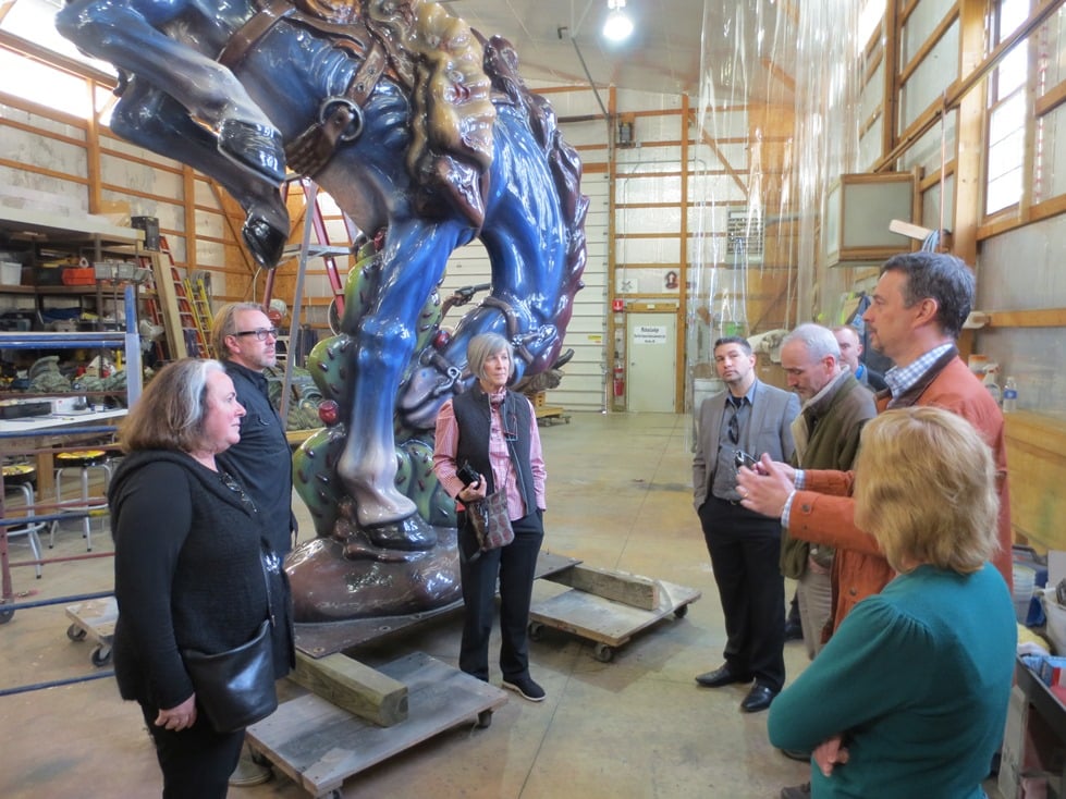 Members of the PPG corporation Jimenez sculpture conservation support team address Susan Jimenez (left), the executive director of the Luis A. Jimenez, Jr. Estate, conservator Jim Gwinner (center) and Smithsonian conservator Helen Ingalls (right). VAQUERO from the Smithsonian American Art Museum is behind them.